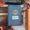 A vintage-style blue notebook with a gold crest and a white label reading 'BERM HIGH SENORS' lies on a wooden surface surrounded by autumn leaves, pinecones, a typewriter, and an orange book. image